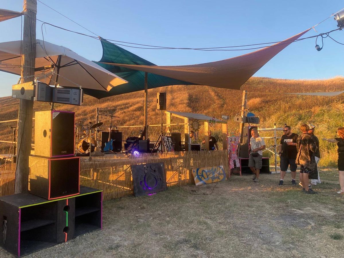 Naturacustica festival stage setup in the Abruzzo countryside at golden hour